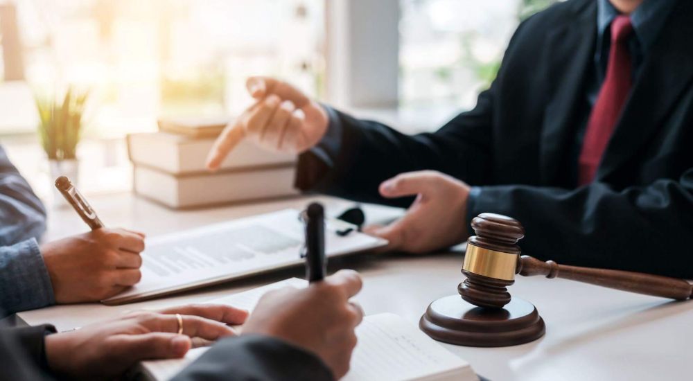 Two people at table with dual judges in court setting