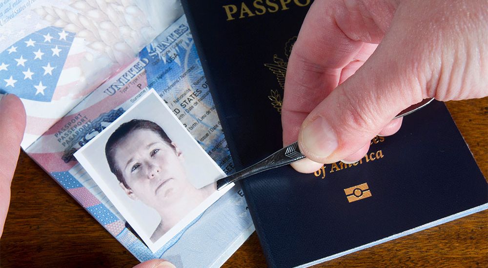 Person swapping a passport photo with tweezers, suggesting identity fraud or travel document tampering.